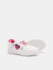 White sneaker with pink accents on a white background