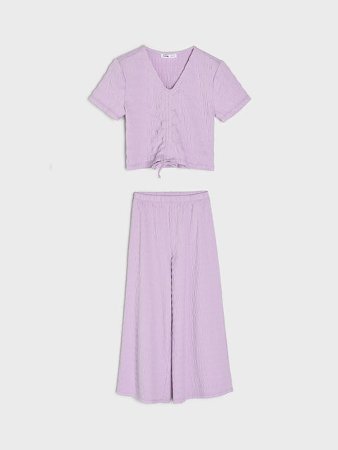 Lavender outfit with top and wide-leg pants on a white background