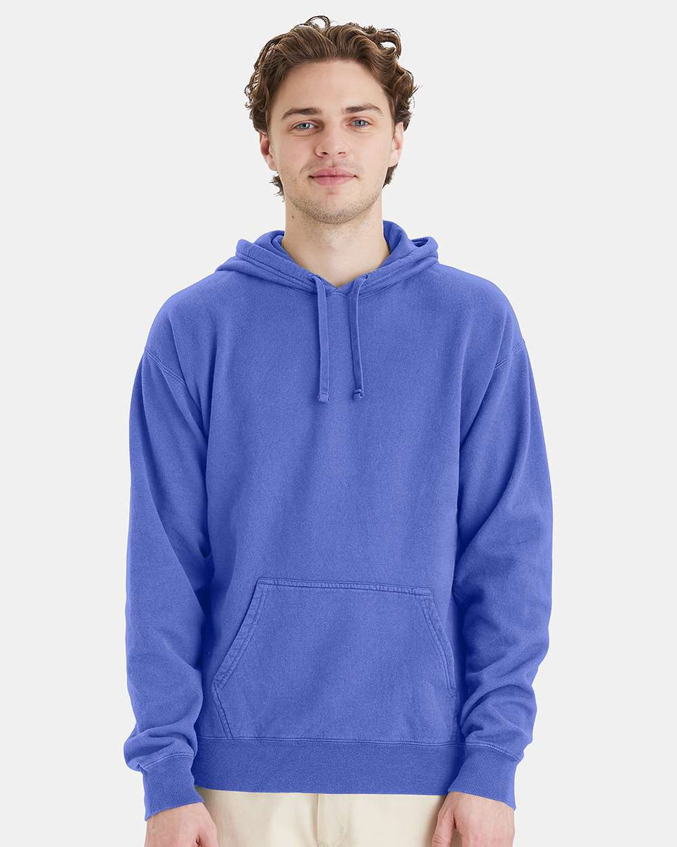 Man wearing a blue hoodie on a light gray background