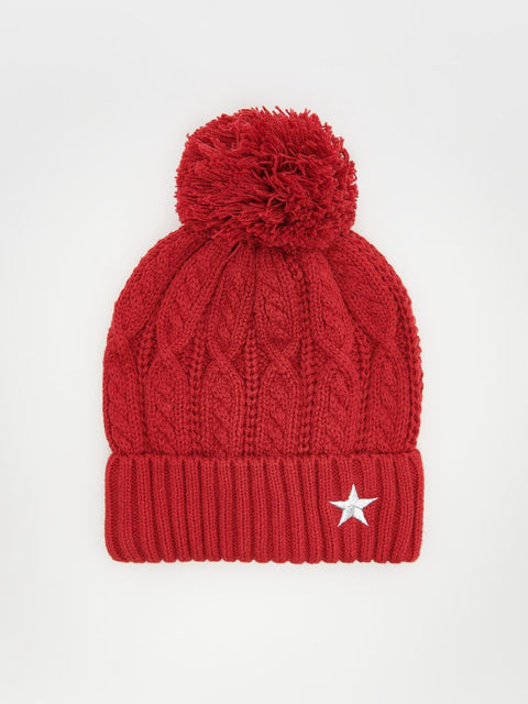 Red knit beanie with a pom-pom on a white background