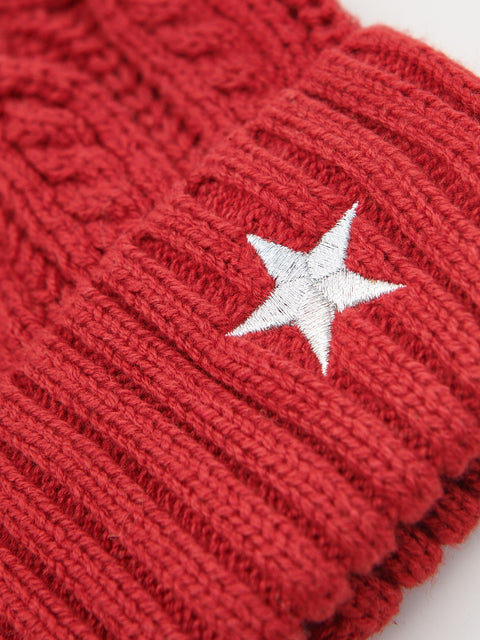 Red knitted beanie with a white star emblem on a light gray background