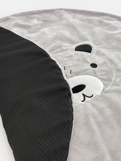 Gray and black cushion with bear design on a white background