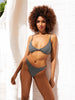 Woman wearing a black and white checkered bikini against a white background