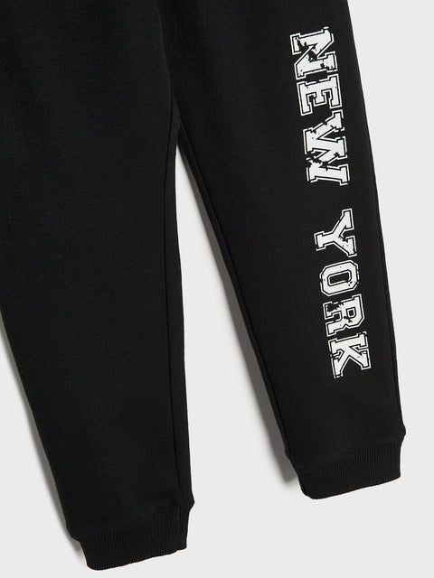 Black sweatpants with 'New York' text on a white background