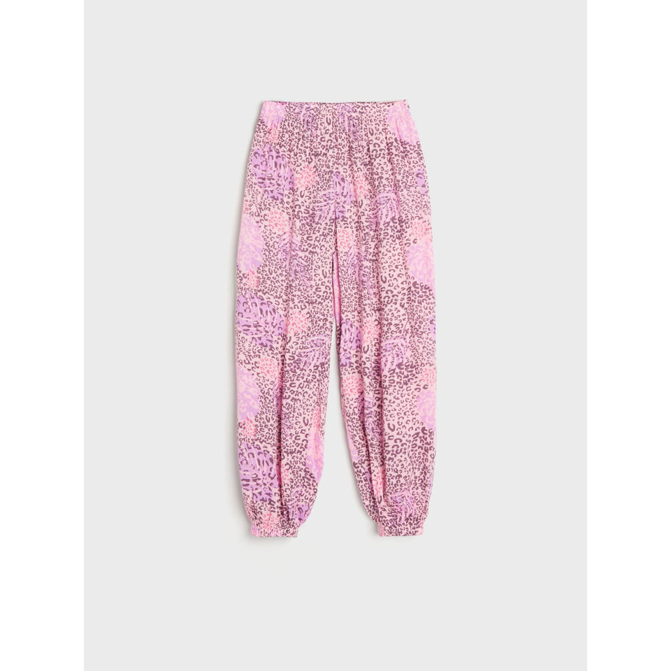 Pink patterned jogger pants with a leopard print design, featuring an elastic waistband and tapered legs with gathered cuffs, shown flat on a light gray background.