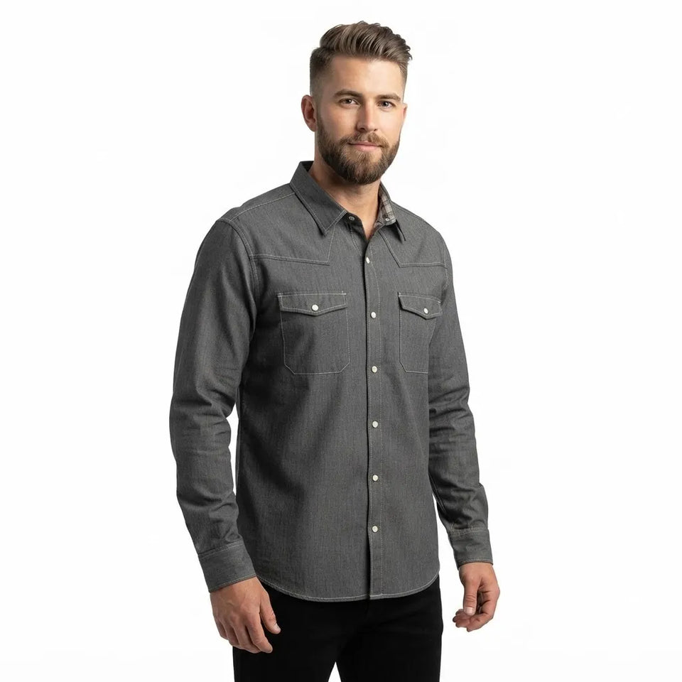 A man wearing a dark gray long-sleeve button-up shirt with two chest pockets, photographed against a plain white background.