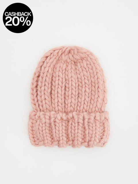 Pink knitted beanie on a light pink background