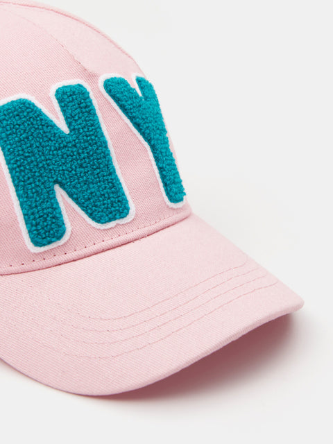 Pink cap with teal letters on a white background