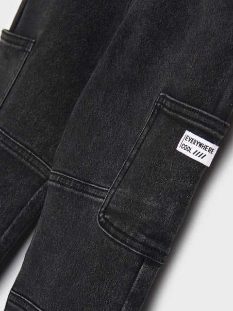 Black pants with a label on the pocket against a white background