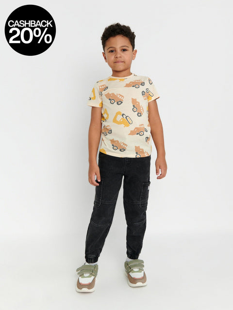 Child wearing a t-shirt with vehicle prints on a white background