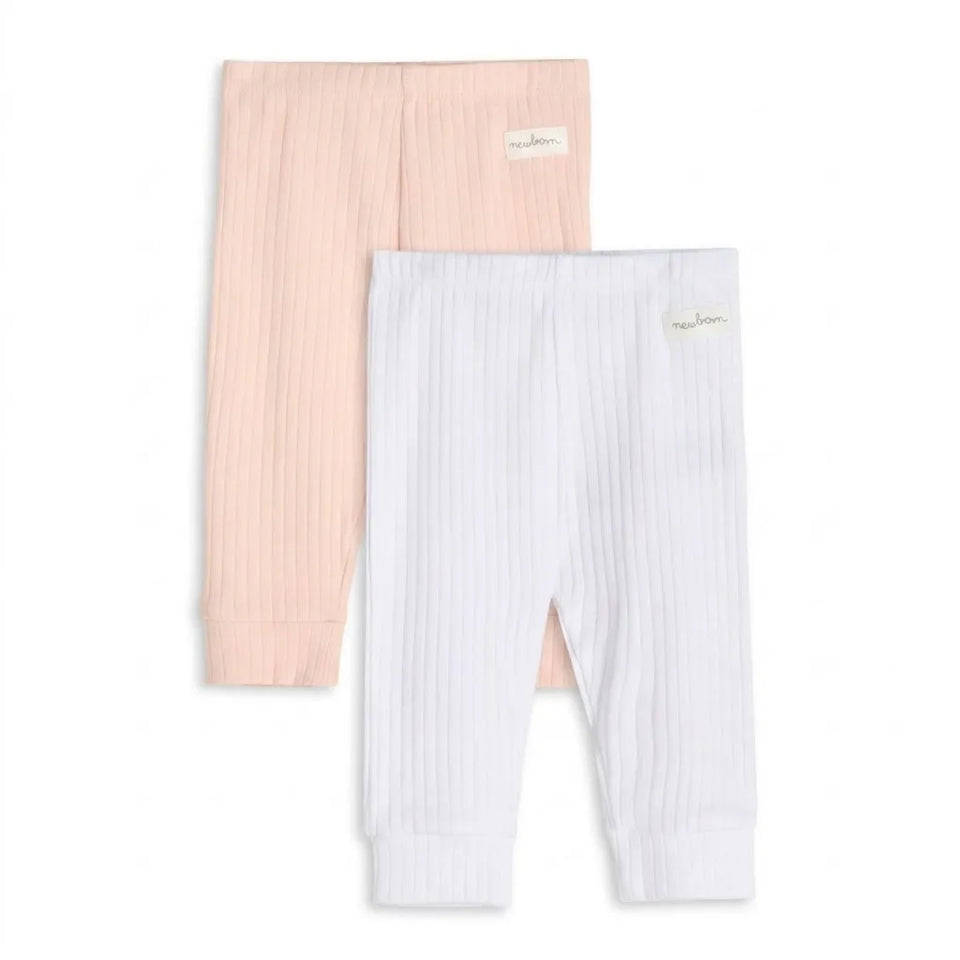Two pairs of ribbed knit baby leggings, one in pale pink and one in white, displayed flat against a white background. Each pair features a small embroidered brand tag on the upper right leg.