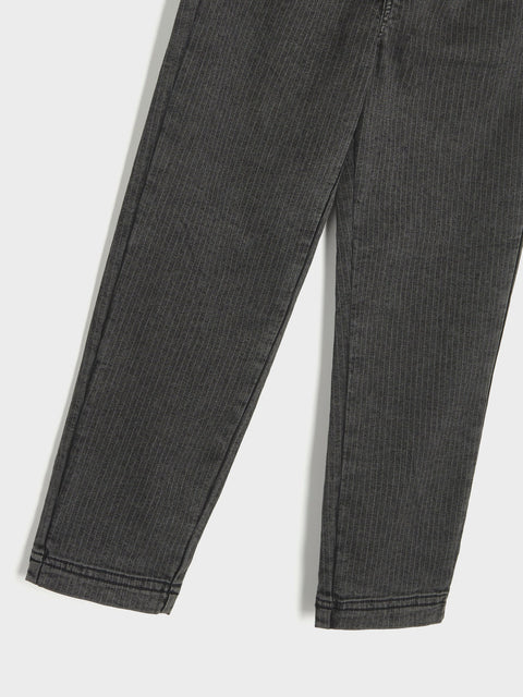 Close-up of dark gray pants on a white background