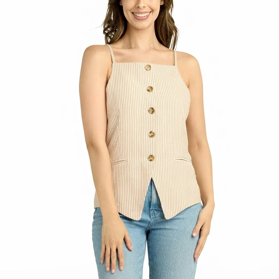 A woman wearing a beige and white vertically striped camisole top with gold buttons down the front, paired with blue jeans, against a plain white background.