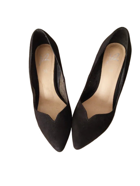 Pair of black high-heeled shoes on a white background