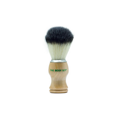 Shaving brush with wooden handle and black bristles on a white background