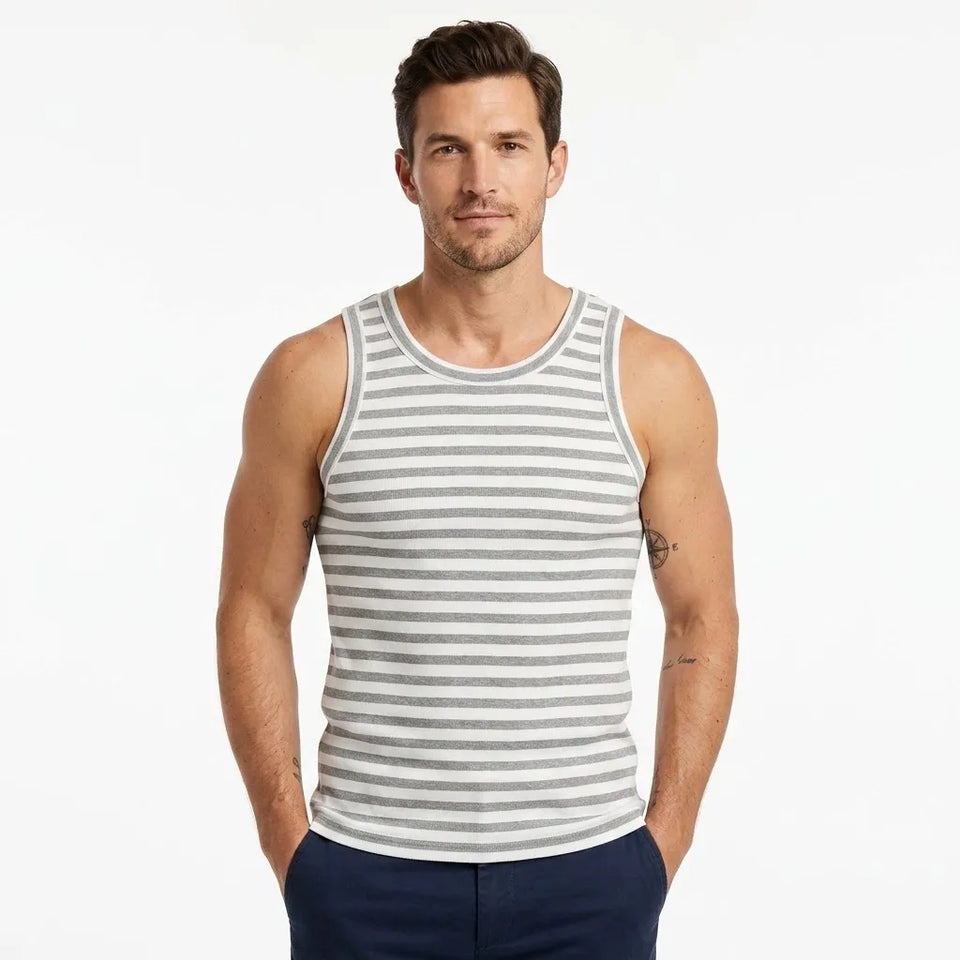 A man modeling a gray and white horizontally striped ribbed tank top against a plain white background.