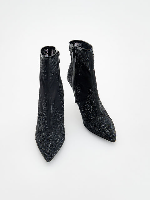 Pair of black glittery ankle boots on a white background