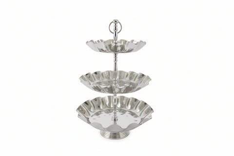 Decorative silver umbrella-shaped object on a dark surface with a window in the background.