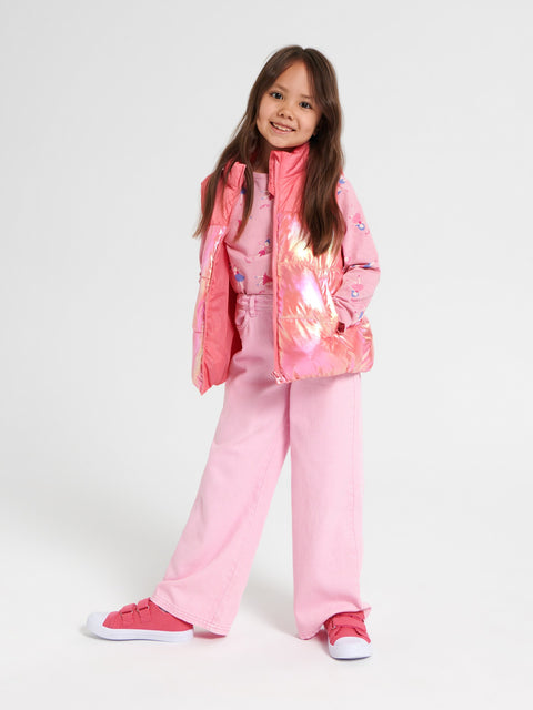 Young girl wearing a pink outfit with a reflective jacket on a white background