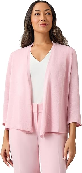 Woman wearing a pink suit with a white top on a white background