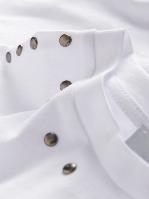 Close-up of a white shirt with metallic buttons on a white background