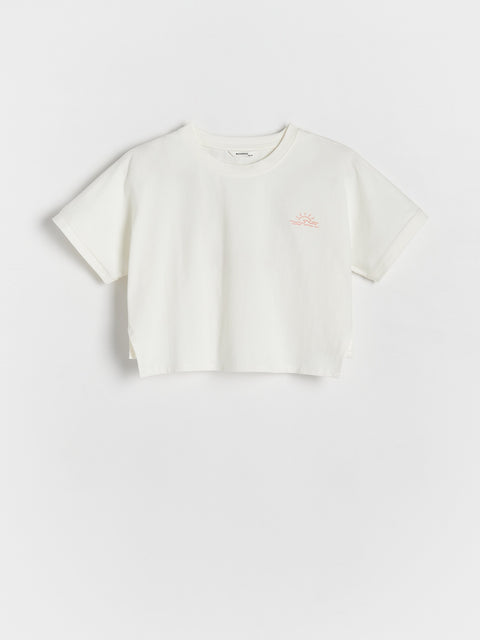 White t-shirt with a small logo on a light gray background