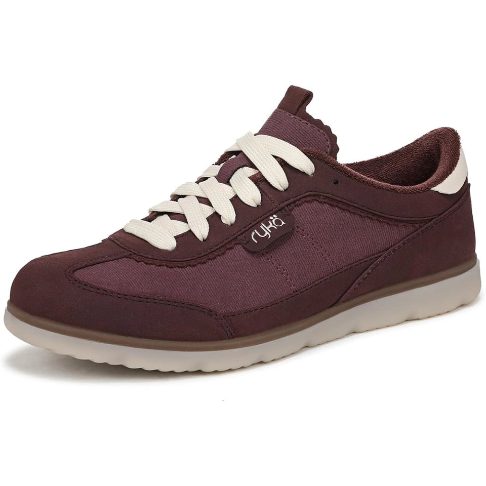 A low-top casual sneaker in a deep burgundy color, featuring cream-colored laces, a cream midsole, and a small silver logo on the side, set against a plain white background.