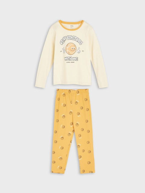 Children's pajama set with long-sleeve top and yellow pants on a light gray background