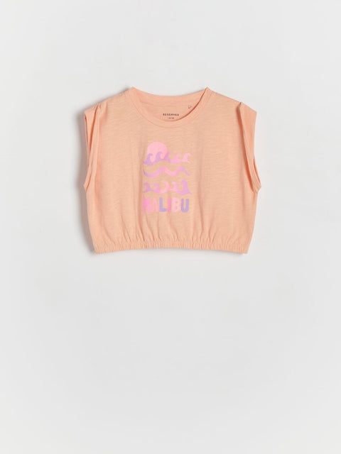 Pink sleeveless top with text on a light gray background