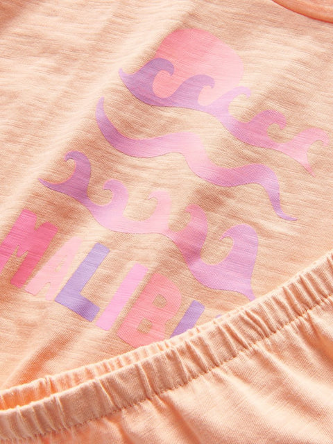 Pink and purple pattern on a peach-colored fabric