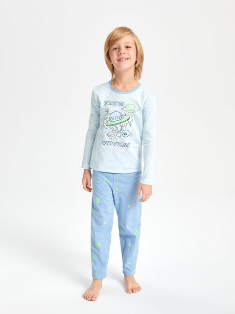 Child wearing a light blue pajama set with space-themed design on a white background