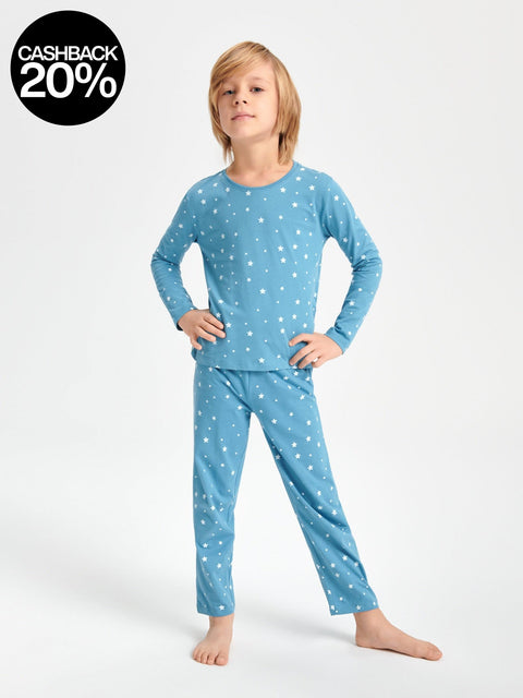 Child wearing blue pajamas with white stars on a white background