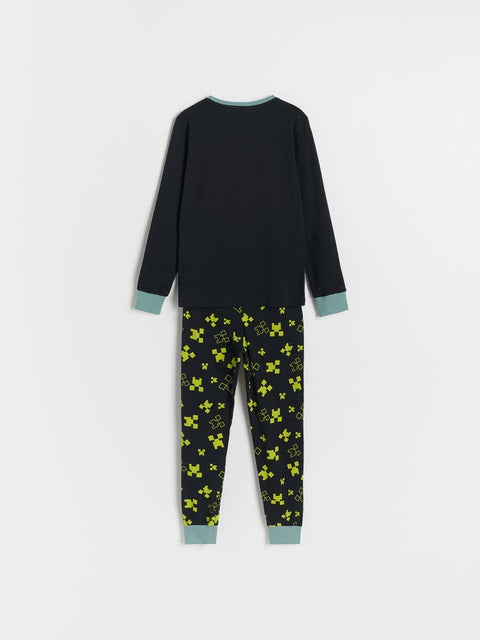 Children's black long-sleeve top and patterned pants on a white background