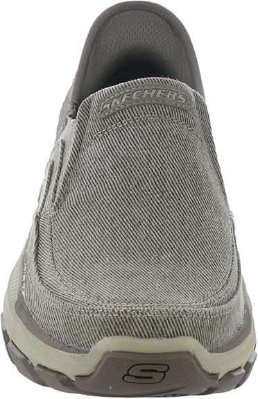 Gray slip-on shoe with 'Skechers' branding on a white background