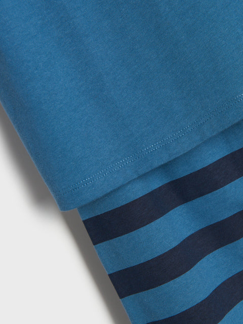Close-up of blue fabric with a textured surface and three black stripes.