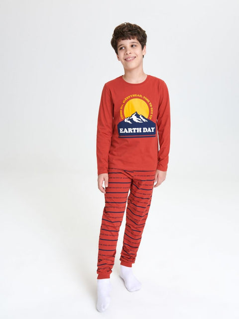 Child wearing a red 'Earth Day' pajama set on a white background