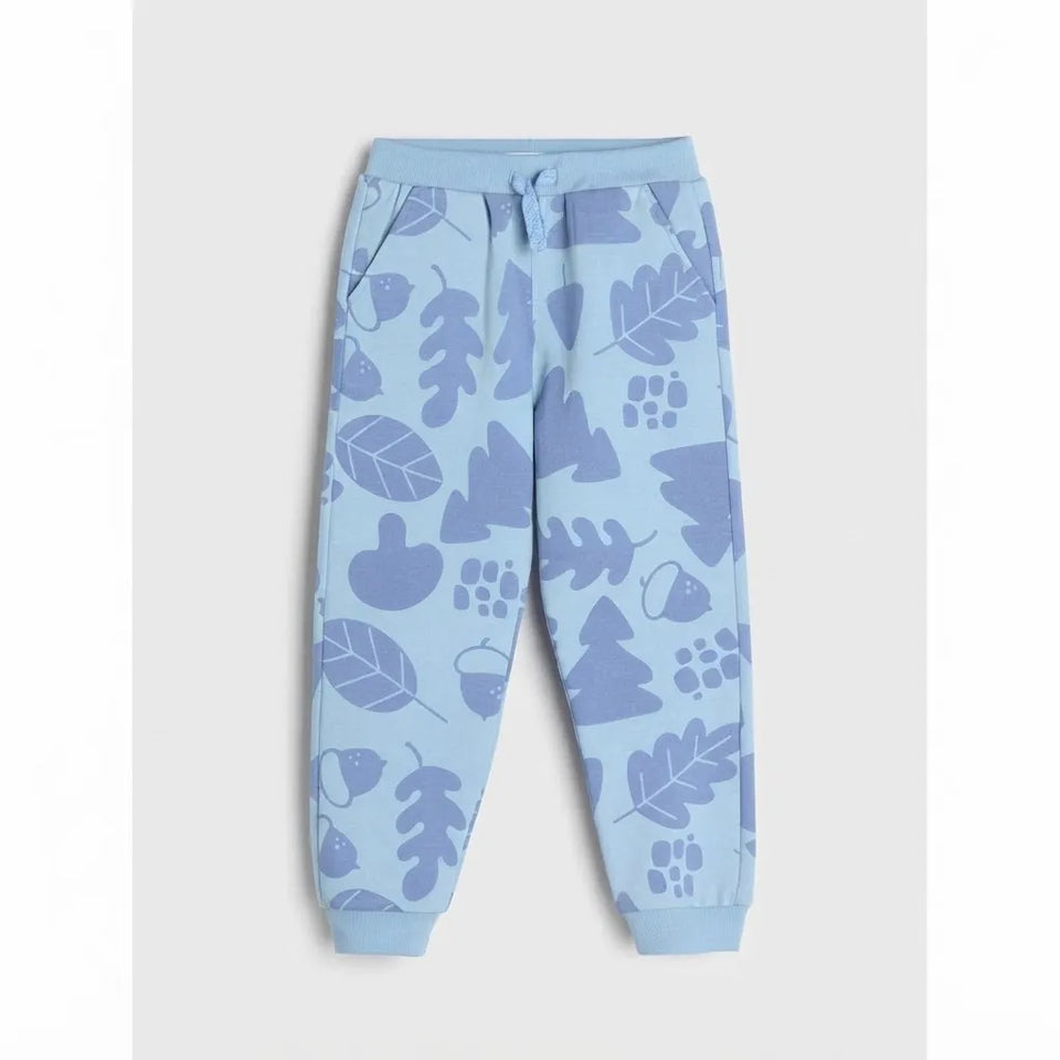 Light blue jogger pants with a darker blue leaf and acorn pattern, featuring a drawstring waist and ribbed cuffs.