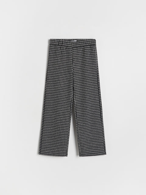 Black and white checkered pants on a light gray background