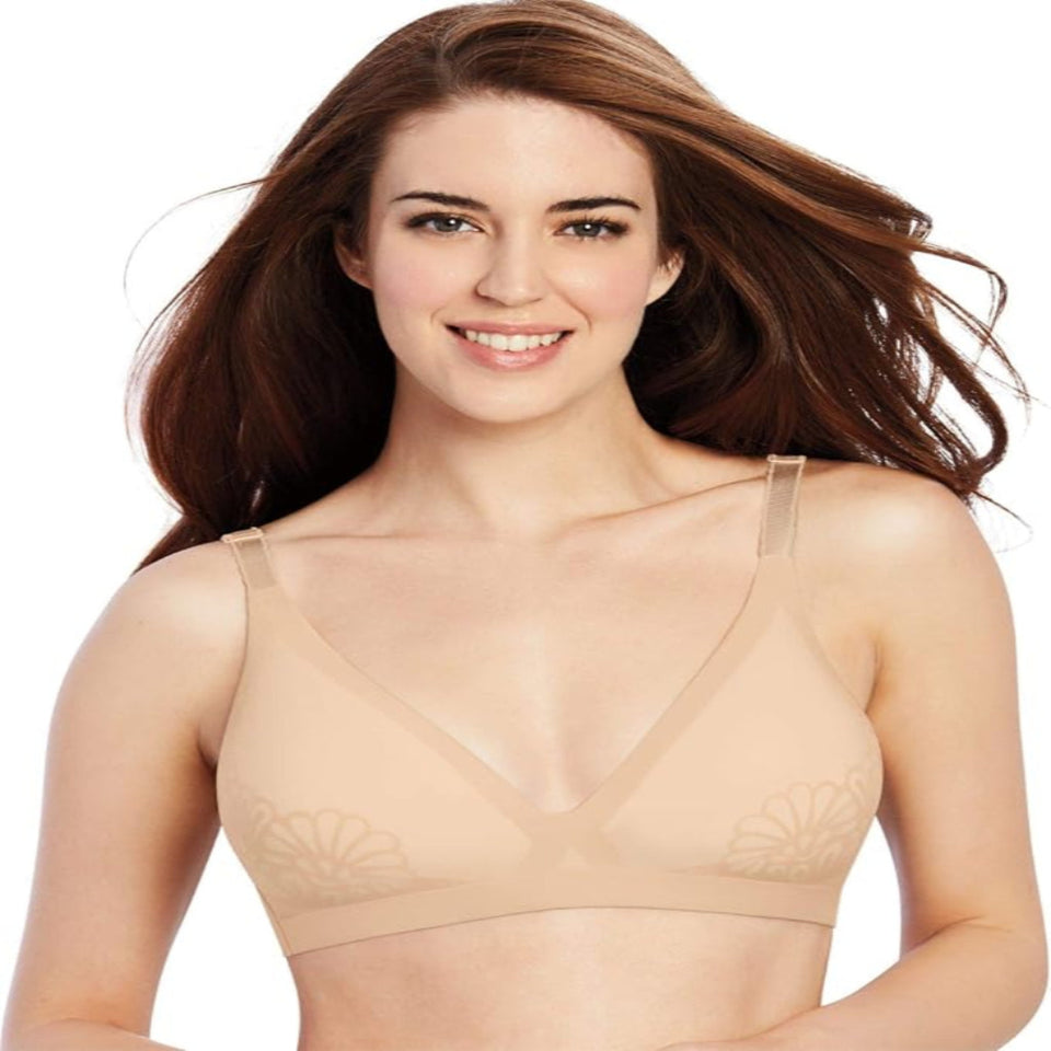 A woman with long brown hair wearing a beige wireless bra with underwire and subtle floral embroidery on the cups, shown against a plain white background.