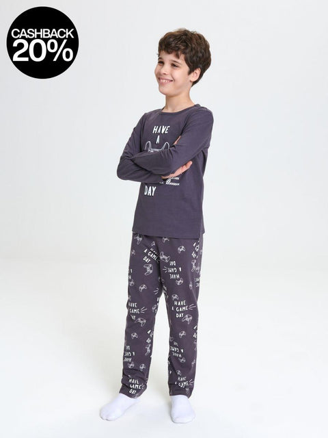 Child wearing a dark gray pajama set with text and animal prints on a white background