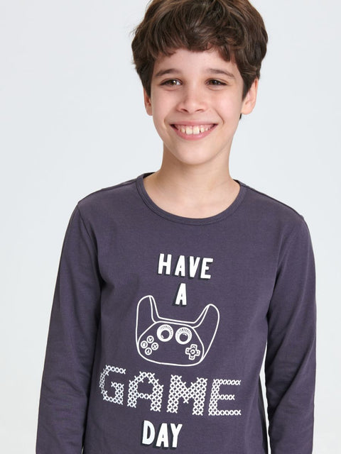 Child wearing a purple long-sleeve shirt with 'Have a Game Day' text and gaming controller graphic on a white background