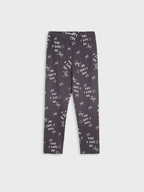 Dark gray leggings with white text and small graphics on a white background