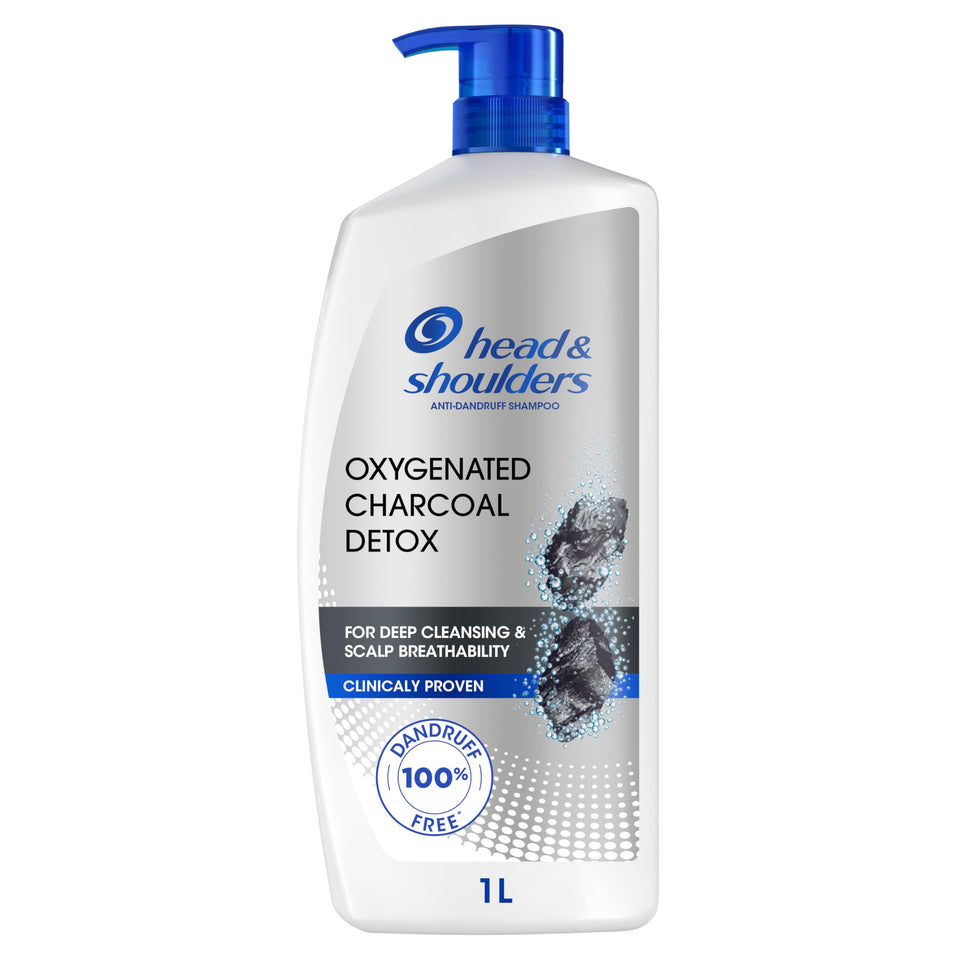 A bottle of Head & Shoulders Oxygenated Charcoal Detox shampoo with a blue pump, labeled for deep cleaning and scalp breathability, 1L in size.