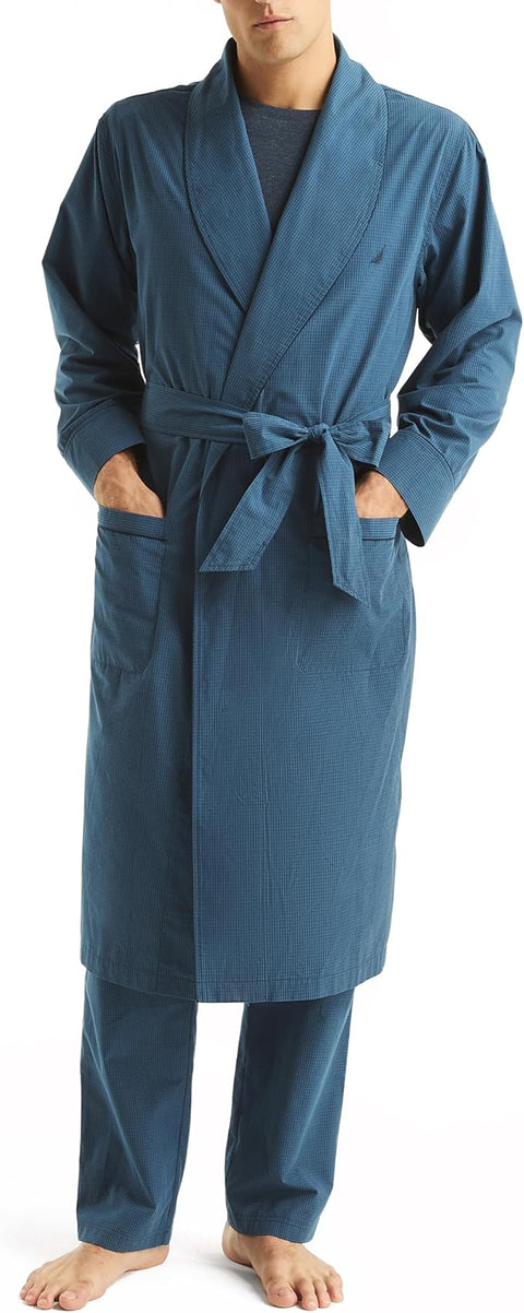 Person wearing a blue robe with a belt, standing against a neutral background