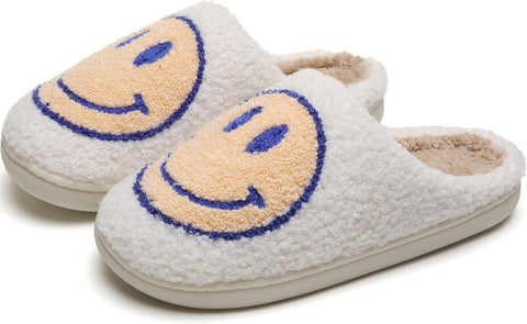 Pair of white slippers with smiley face design on a white background