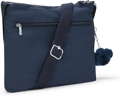 Navy blue crossbody bag with a pom-pom charm on a white background
