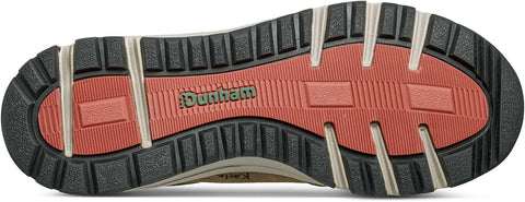 Close-up of a shoe sole with red tread pattern and 'Dunham' branding.