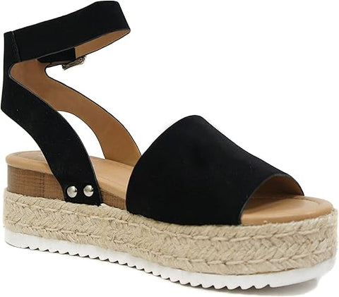 Black sandal with a woven platform on a white background