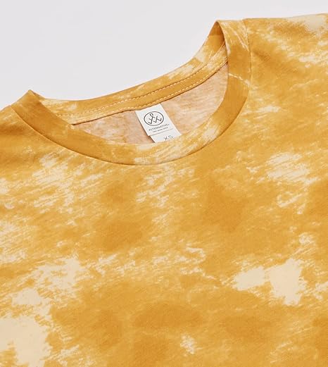 Close-up of a yellow tie-dye shirt with a brand tag on a white background