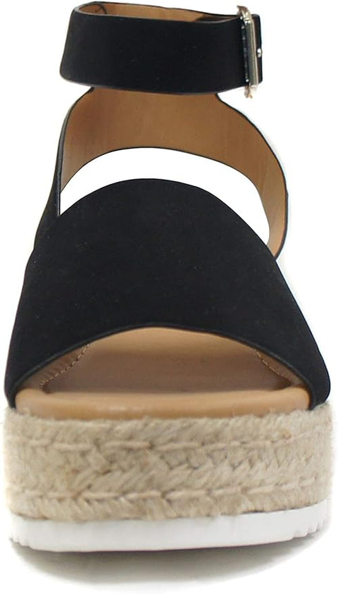 Black wedge sandal with espadrille sole on a white background